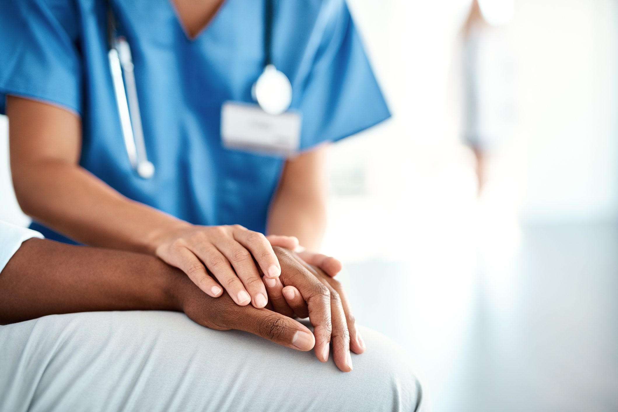 Cropped shot of an unrecognizable female nurse comforting a patient in the hospital