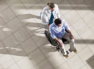 Doctor pushing man in wheelchair