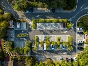 Parking lot aerial with trees and cars